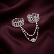 Two Arka diamond rings joined by a marquise diamond chain, on imperial wine silk